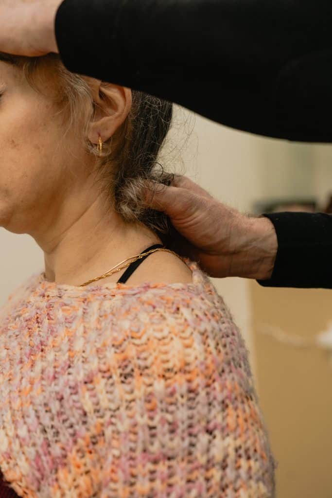 Chiropractor examining a patient’s neck during a first chiropractic visit in Tulsa