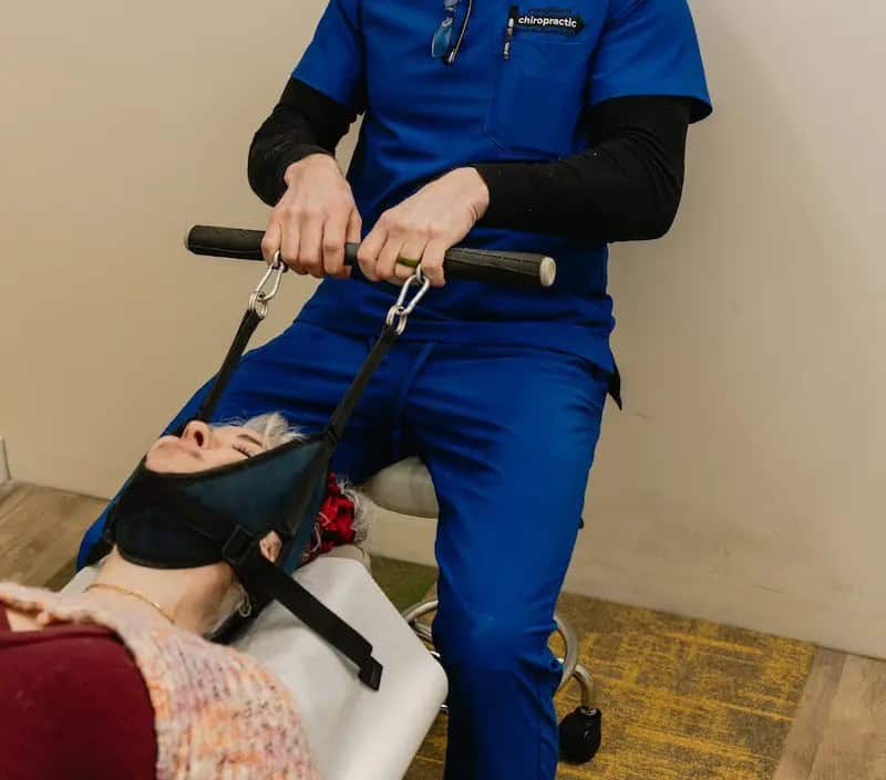 spinal decompression chiropractor in Tulsa performing y-strap adjustment at Vanguard Chiropractic
