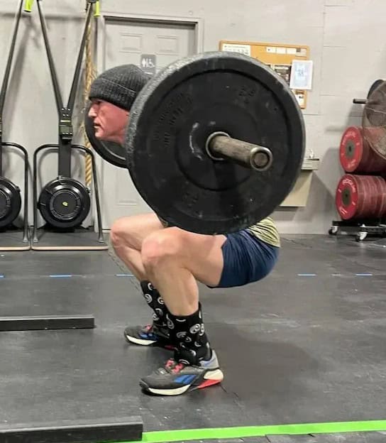 mobility chiropractor in Tulsa patient performing back squat demonstrating full range of motion at Vanguard Chiropractic Brookside