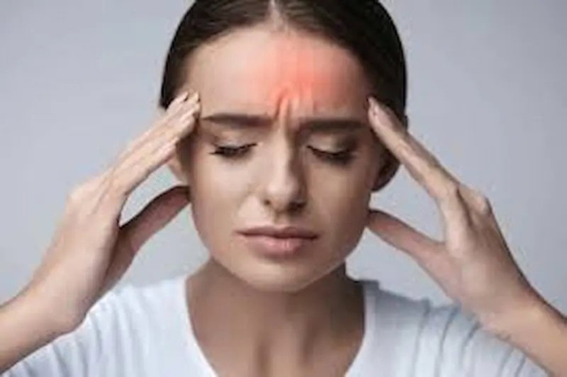 Headache and migraine chiropractor in Tulsa woman holding head with tension headache pain